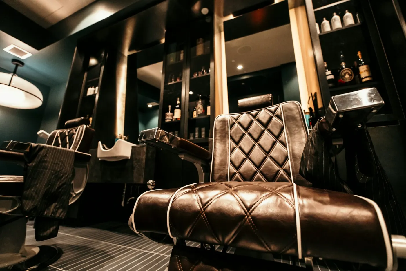 A barbershop chair in front of a mirror